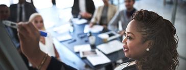 Woman presenting information to coworkers